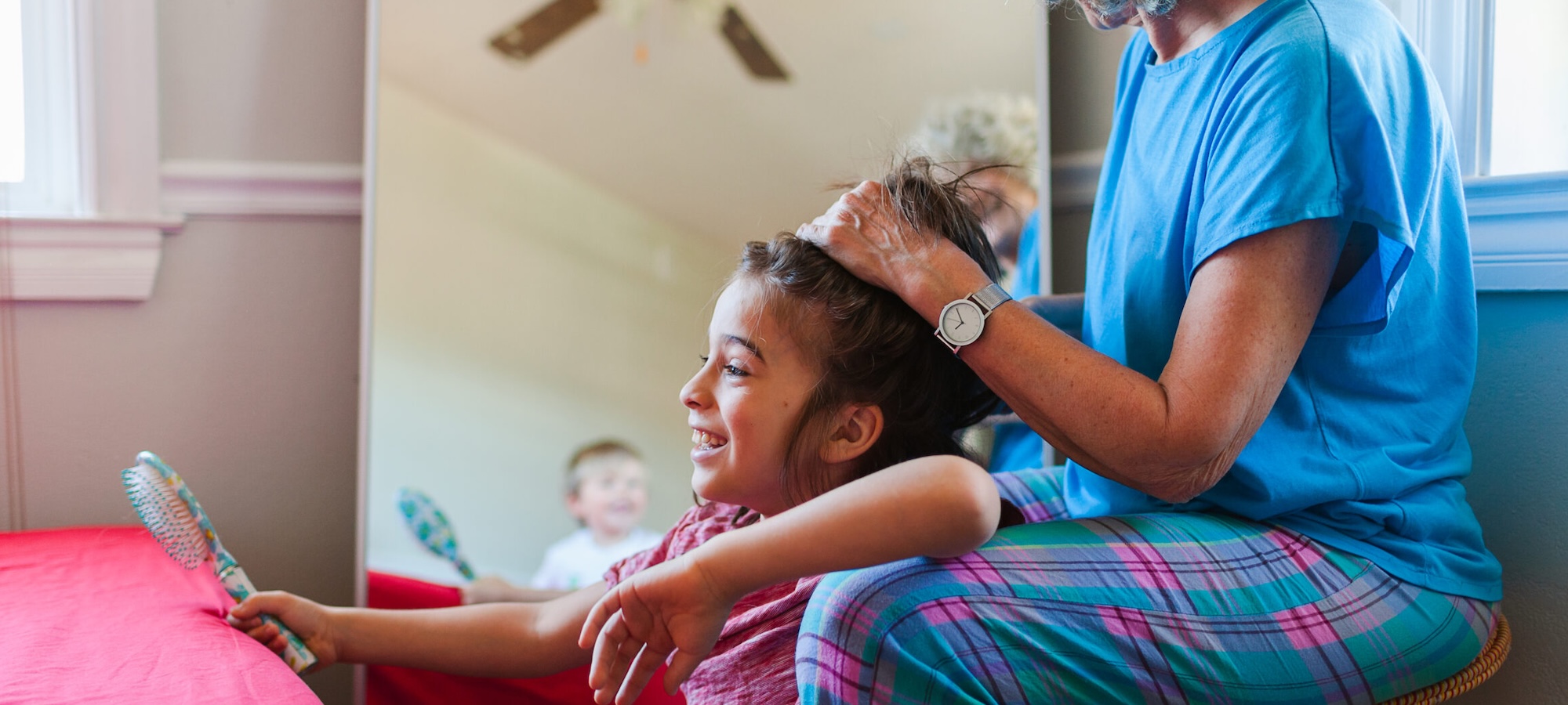 Foster carer brushes child's hair